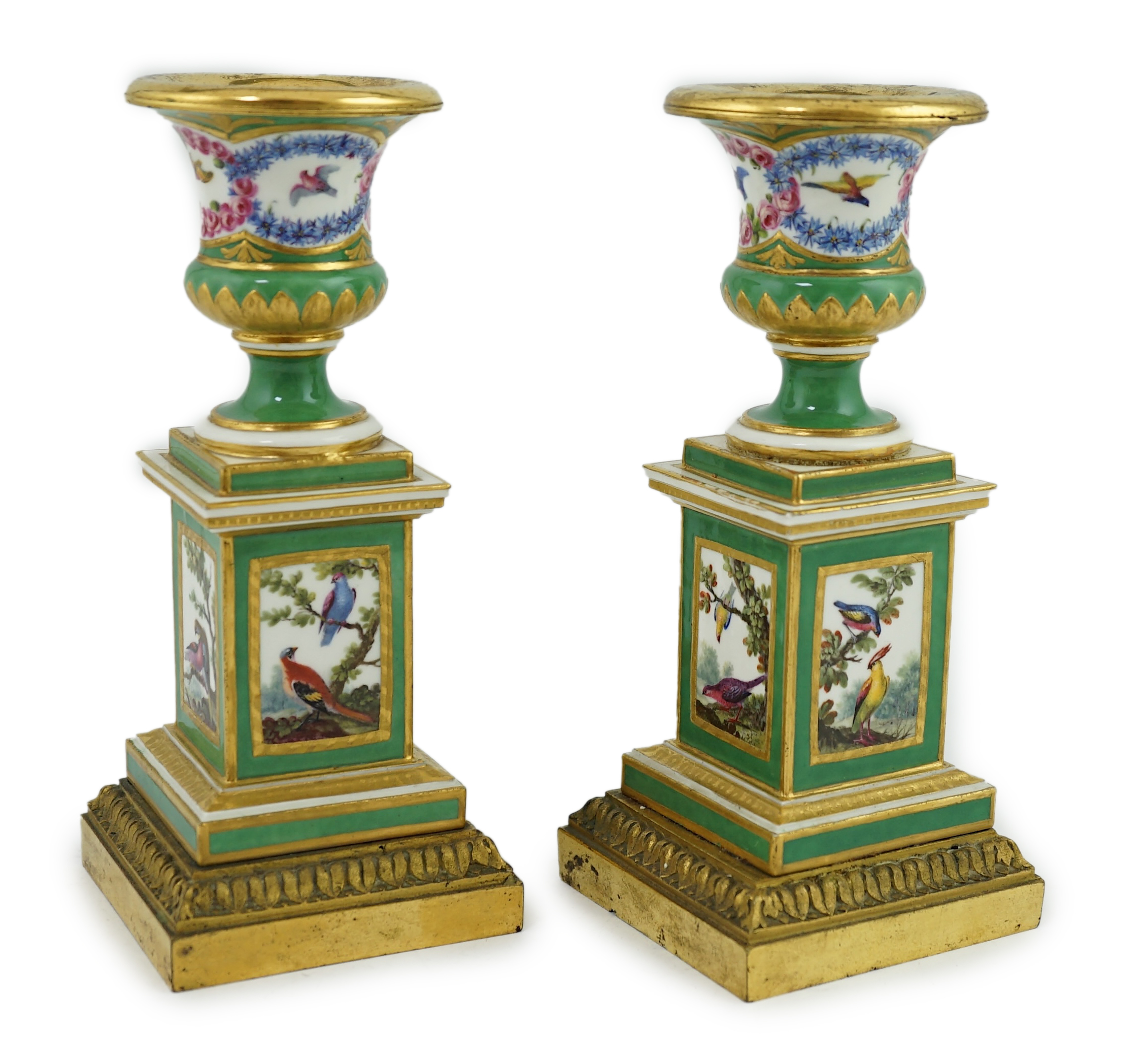 A pair of late 18th century Sevres ormolu mounted porcelain candlesticks, in the manner of Chappuis L'Aine